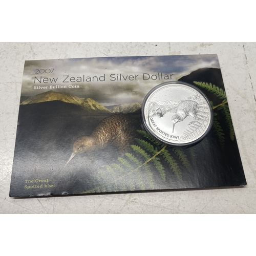 20 - A collection of five New Zealand $1 silver coins in presentation packs and a 1998 New Zealand $10 wi... 
