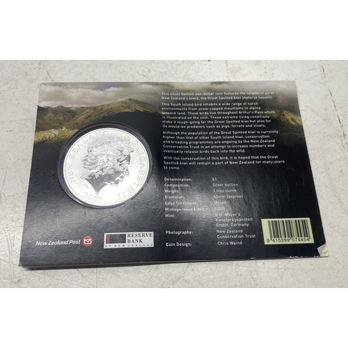 20 - A collection of five New Zealand $1 silver coins in presentation packs and a 1998 New Zealand $10 wi... 