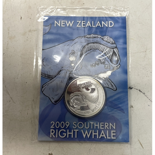 33 - A collection of seven New Zealand $1 silver coins in presentation packs, combined weight of coins 20... 