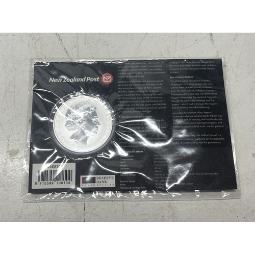 33 - A collection of seven New Zealand $1 silver coins in presentation packs, combined weight of coins 20... 