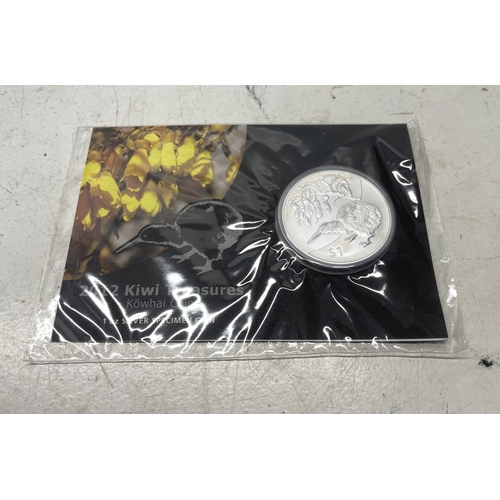 33 - A collection of seven New Zealand $1 silver coins in presentation packs, combined weight of coins 20... 