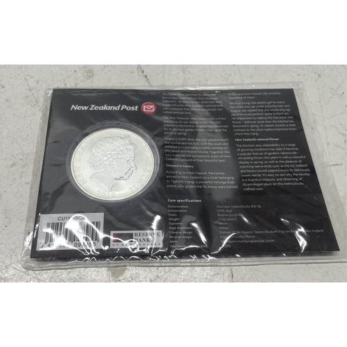 33 - A collection of seven New Zealand $1 silver coins in presentation packs, combined weight of coins 20... 