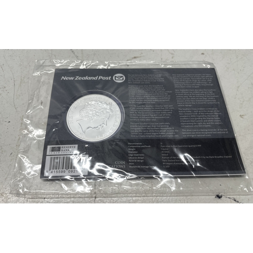 33 - A collection of seven New Zealand $1 silver coins in presentation packs, combined weight of coins 20... 