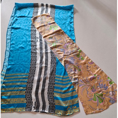 18 - Biba- A silk turquoise wrap having a black, silver and gold Biba design with hand-rolled edges toget... 