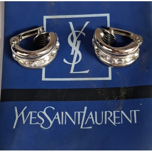 16 - YSL- A pair of late 20th Century YSL silver tone and white crystal clip on hoop earrings, made in Fr... 
