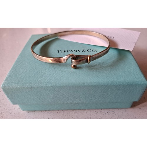 9 - Tiffany & Co- A Sterling silver and 18ct gold 'hook and eye' bracelet stamped 925 and 750, 12.4g, ha... 