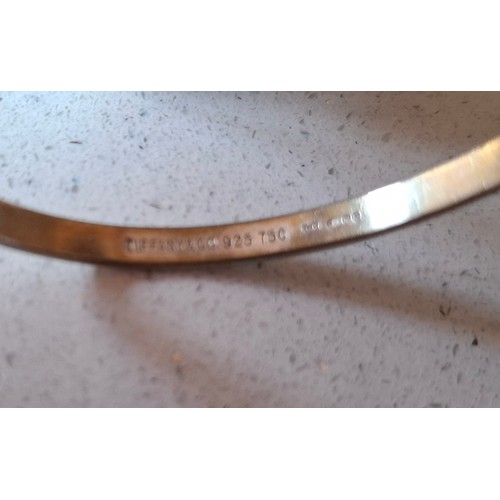 9 - Tiffany & Co- A Sterling silver and 18ct gold 'hook and eye' bracelet stamped 925 and 750, 12.4g, ha... 