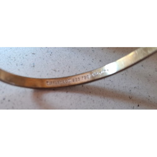 9 - Tiffany & Co- A Sterling silver and 18ct gold 'hook and eye' bracelet stamped 925 and 750, 12.4g, ha... 