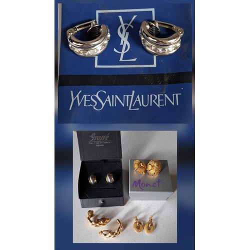 YSL- A pair of late 20th Century YSL silver tone and white crystal clip on hoop earrings, made in France together with a pair of 2-tone Grosse earrings in branded box, a pair of gold tone Monet earrings, a pair of gold tone Napier earrings and a pair of over-sized Givenchy gold tone half hoop earrings. Location:Cab
If there is no condition report, please request