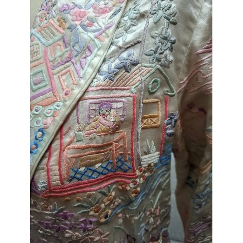 5 - A 1930's Chinese cream silk jacket having embroidered images of garden scenes in pinks, lilac, peach... 