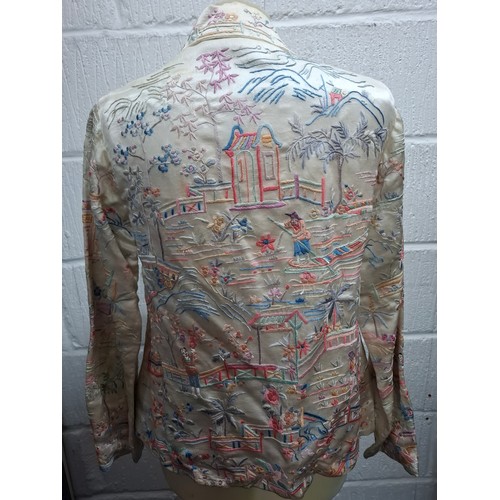 5 - A 1930's Chinese cream silk jacket having embroidered images of garden scenes in pinks, lilac, peach... 