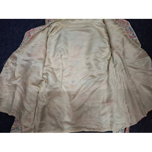 5 - A 1930's Chinese cream silk jacket having embroidered images of garden scenes in pinks, lilac, peach... 