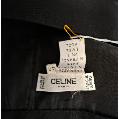 13 - Celine and MiuMiu- A Celine black wool skirt having 3 branded buttons to the front fastening, pleats... 