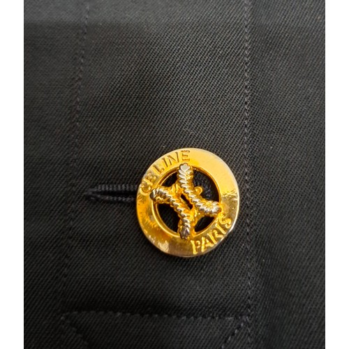 13 - Celine and MiuMiu- A Celine black wool skirt having 3 branded buttons to the front fastening, pleats... 