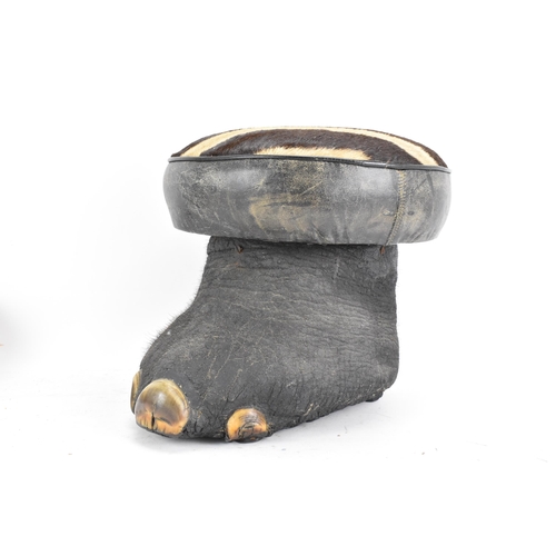 246 - Taxidermy: A late 19th/early 20th century Elephants foot fashioned into a stool, having a zebra skin... 