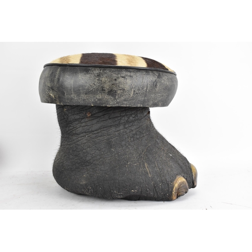 246 - Taxidermy: A late 19th/early 20th century Elephants foot fashioned into a stool, having a zebra skin... 