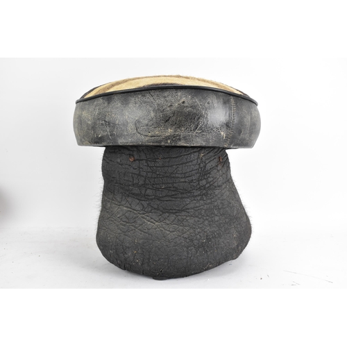 246 - Taxidermy: A late 19th/early 20th century Elephants foot fashioned into a stool, having a zebra skin... 