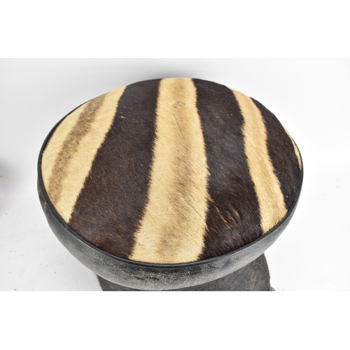 246 - Taxidermy: A late 19th/early 20th century Elephants foot fashioned into a stool, having a zebra skin... 