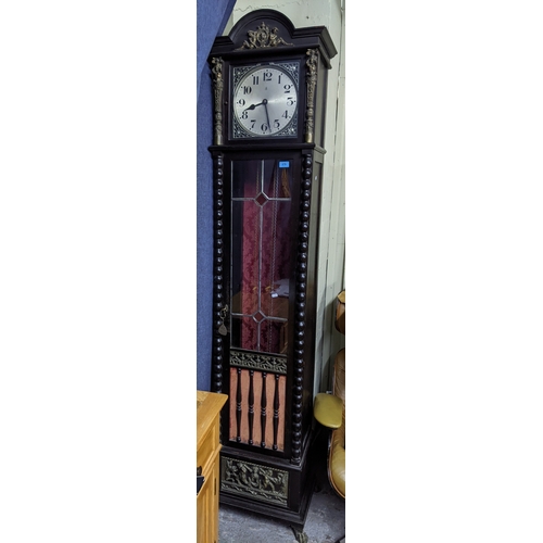 275 - A German oak cased longcase clock, the silvered dial with arabic numerals and pierced spandrels, mar... 