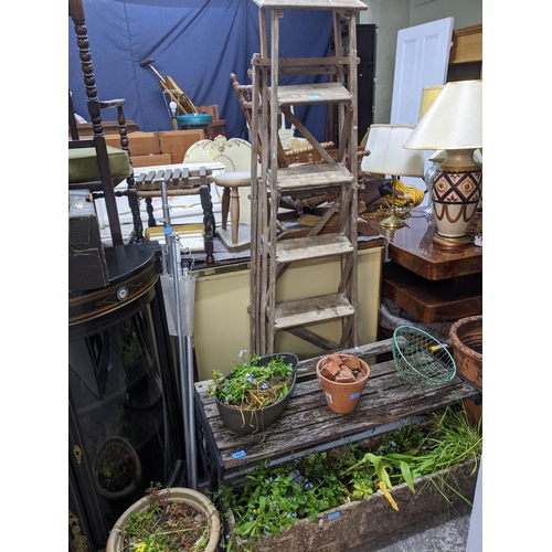 262 - A selection of weathered garden concrete and terracotta planters and pots, to include a concrete tro... 