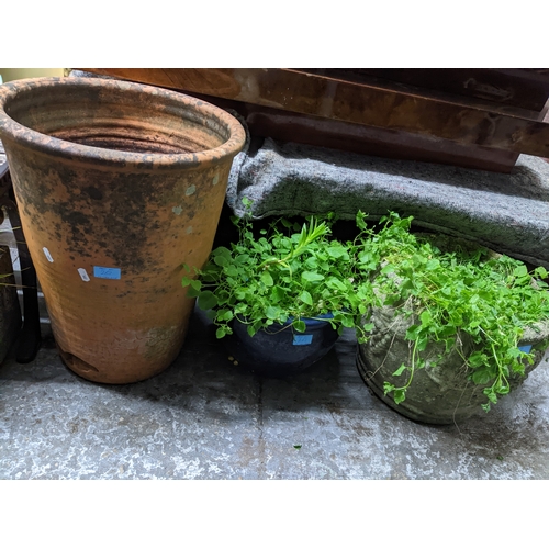 262 - A selection of weathered garden concrete and terracotta planters and pots, to include a concrete tro... 