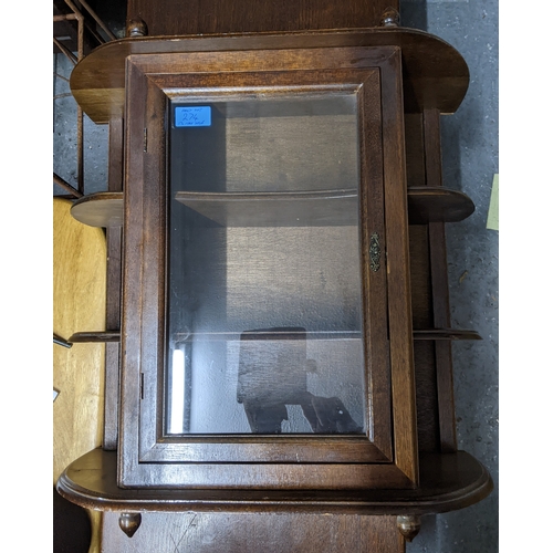 274 - An Art Deco walnut bow fronted display cabinet, twin glazed doors below an extended back, glass inte... 