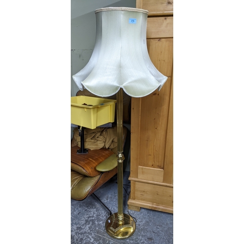 276 - A brass effect standard lamp on circular base with fabric shade; and a group of porcelain table lamp... 