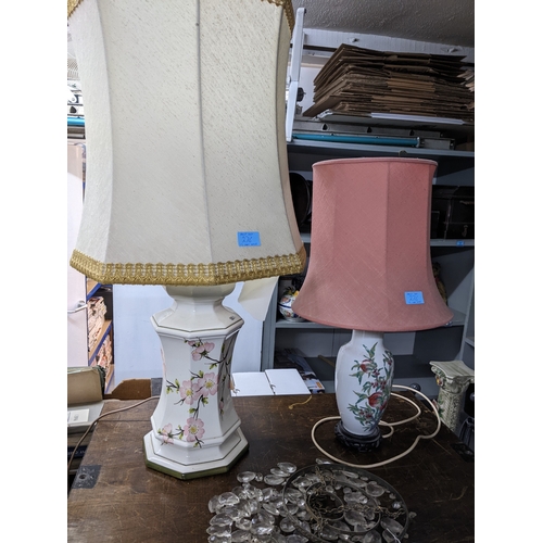 276 - A brass effect standard lamp on circular base with fabric shade; and a group of porcelain table lamp... 