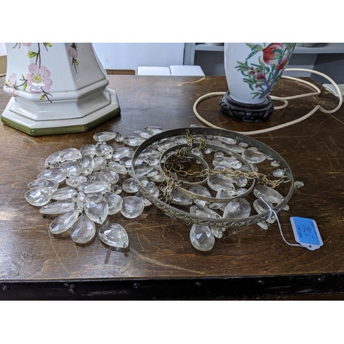 276 - A brass effect standard lamp on circular base with fabric shade; and a group of porcelain table lamp... 