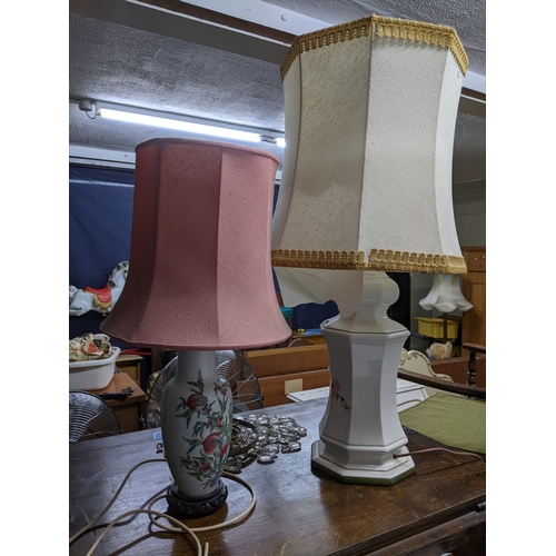 276 - A brass effect standard lamp on circular base with fabric shade; and a group of porcelain table lamp... 