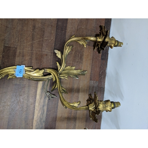192 - A pair of French Louis XV style brass wall sconces with a gilded finish
Location:
If there is no con... 