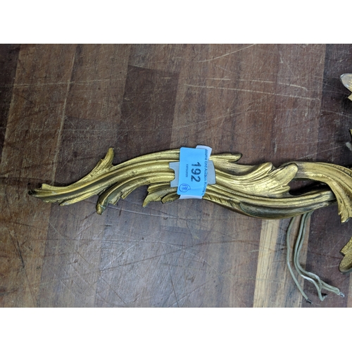 192 - A pair of French Louis XV style brass wall sconces with a gilded finish
Location:
If there is no con... 