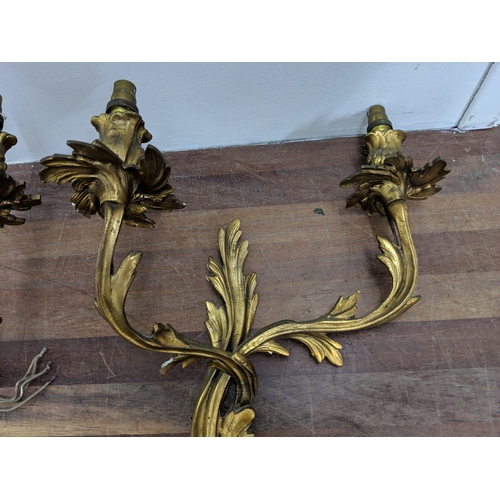 192 - A pair of French Louis XV style brass wall sconces with a gilded finish
Location:
If there is no con... 