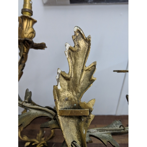 192 - A pair of French Louis XV style brass wall sconces with a gilded finish
Location:
If there is no con... 