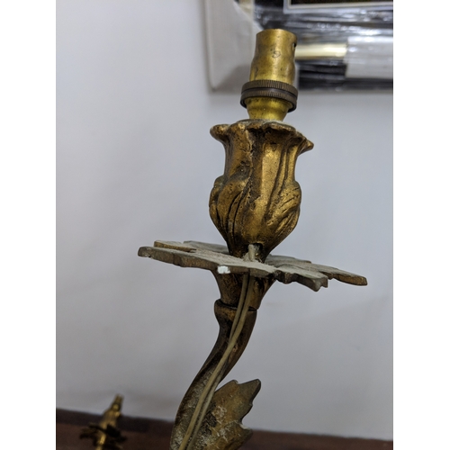 192 - A pair of French Louis XV style brass wall sconces with a gilded finish
Location:
If there is no con... 