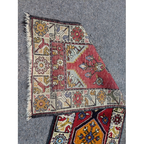 198 - A handwoven Turkish runner with cream blue and orange central medallions with a cream stylized borde... 