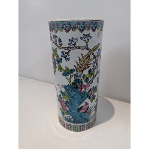 38 - A pair of 20th century Chinese famille rose porcelain cylinder vases decorated with peacocks with re... 