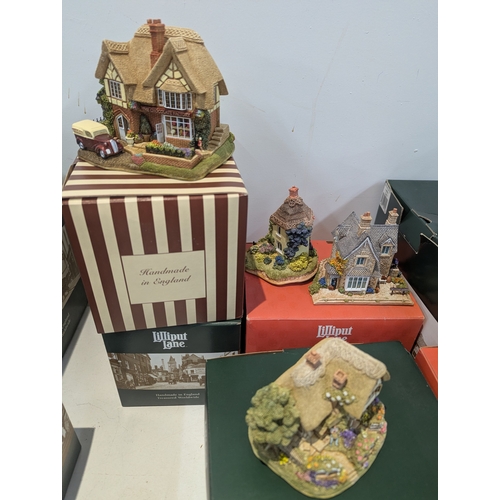 A large collection of Lilliput Lane cottages in various sizes all