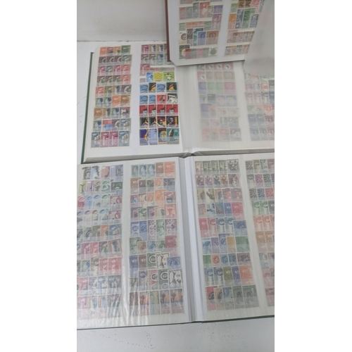 249 - A collection of stamps from around the world housed in five albums from Brazil, Egypt, Ghana, Poland... 