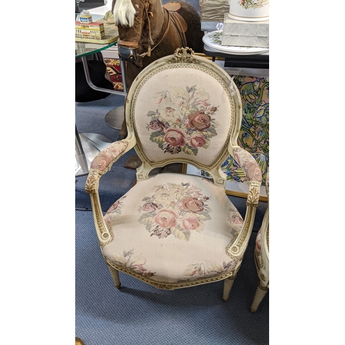 12 - A pair of early/mid 20th century French armchairs, having acanthus carved scroll arms, tapestry upho... 