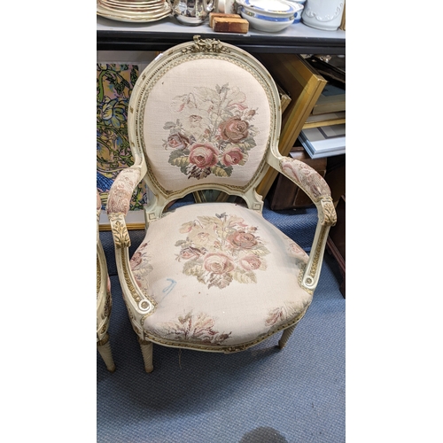 12 - A pair of early/mid 20th century French armchairs, having acanthus carved scroll arms, tapestry upho... 