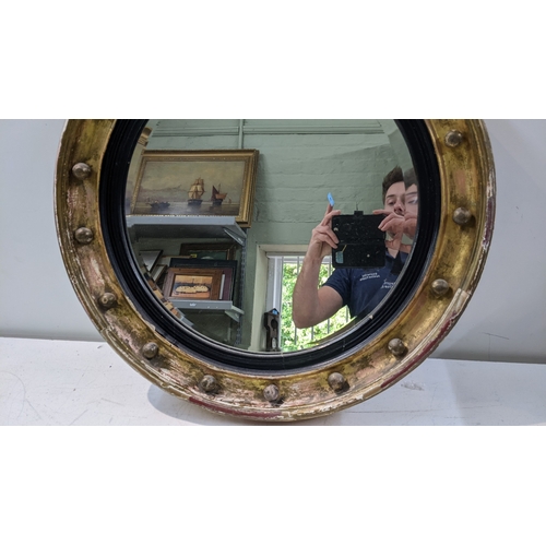 19 - A 19th century gilt butlers mirror having a later bevelled glass plate with applied roundels, 62cm d... 