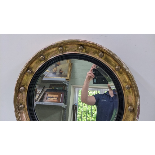19 - A 19th century gilt butlers mirror having a later bevelled glass plate with applied roundels, 62cm d... 
