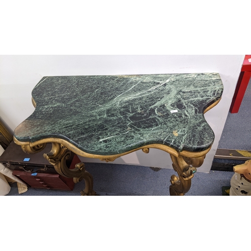 291 - A reproduction French side table, having a marble effect top, serpentine front and on two gilt paint... 