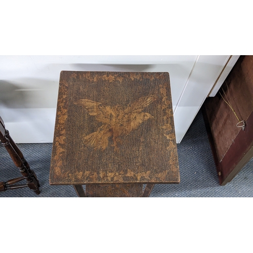 294 - An early 20th century Liberty style occasional table, the top and under-tier decorated in pokerwork ... 