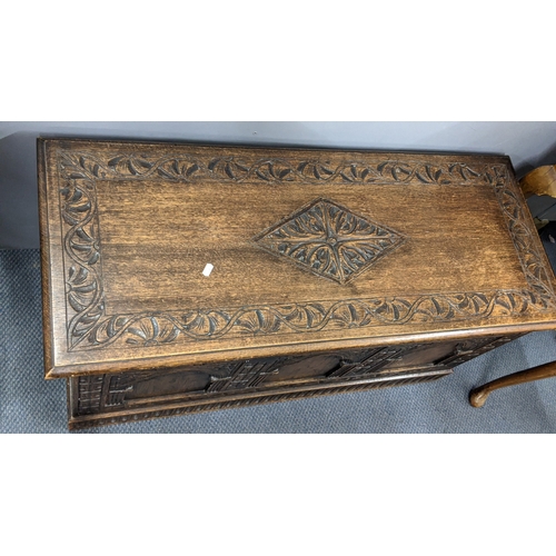 305 - A 1930's oak blanket chest, carved all over with repeating designs on a plinth base, 52.5cm h x 106c... 