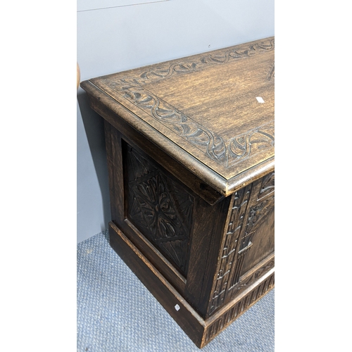 305 - A 1930's oak blanket chest, carved all over with repeating designs on a plinth base, 52.5cm h x 106c... 