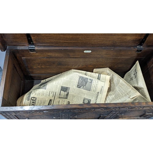 305 - A 1930's oak blanket chest, carved all over with repeating designs on a plinth base, 52.5cm h x 106c... 