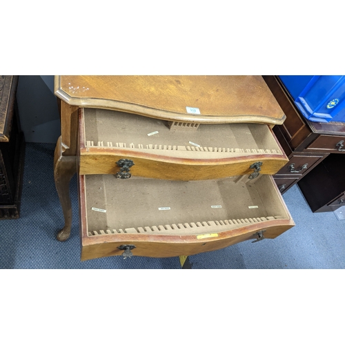 312 - A mid 20th century two drawer cutlery table having a serpentine front and on cabriole legs, 77.5cm h... 