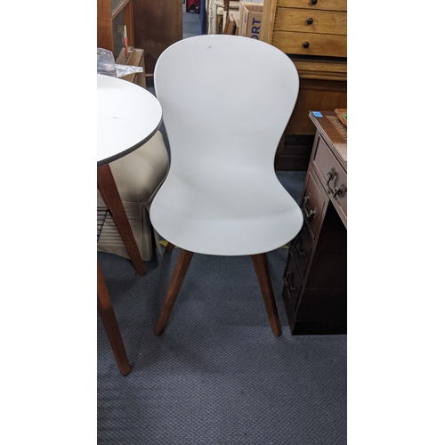 320 - A modern circular topped table with an under-tier below, 75cm h x 67.5cm w, together with two matchi... 